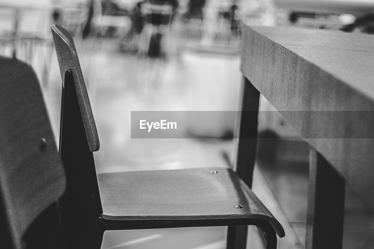 Close-up of empty chair by table in restaurant