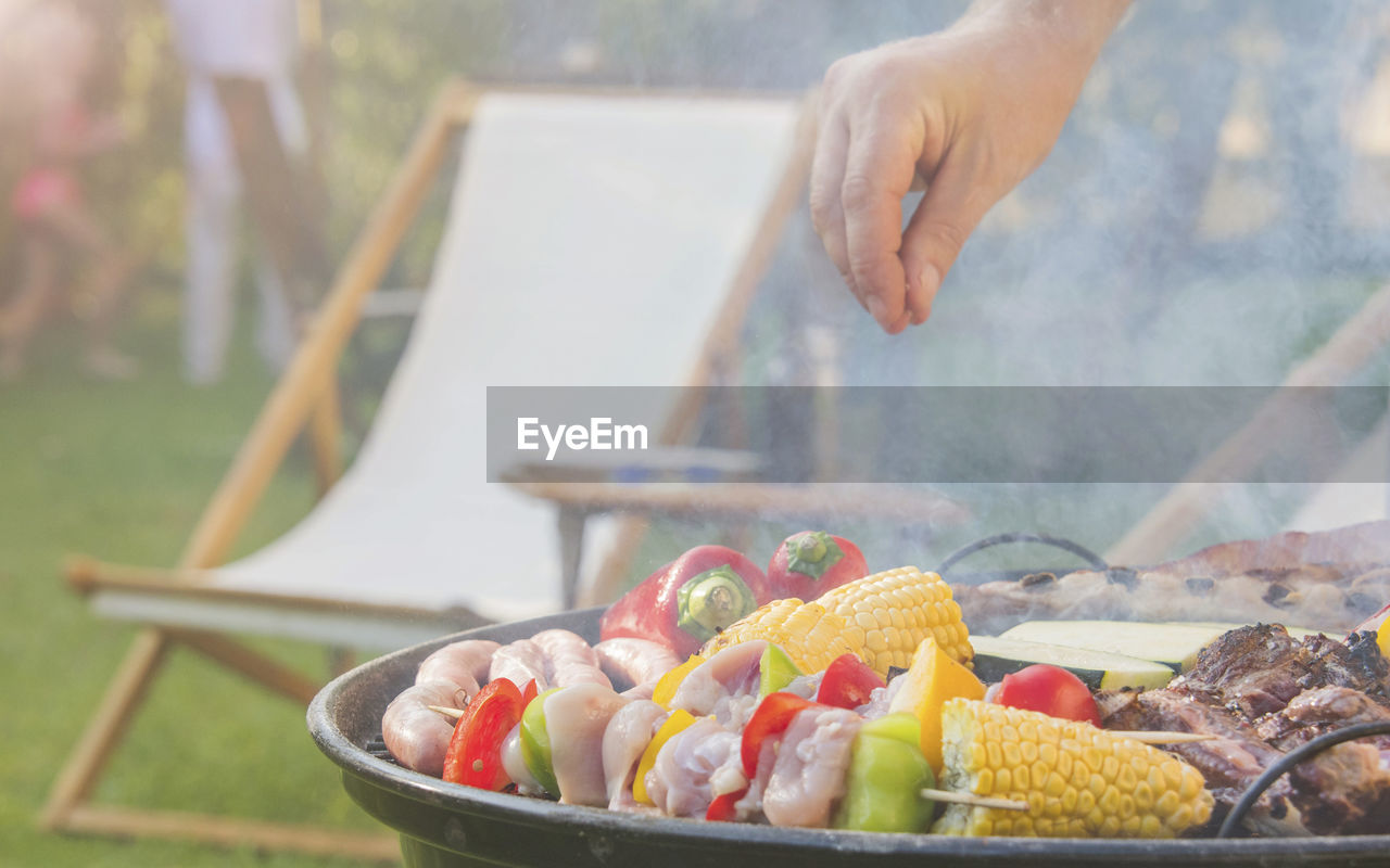 cropped hand of person preparing food on table