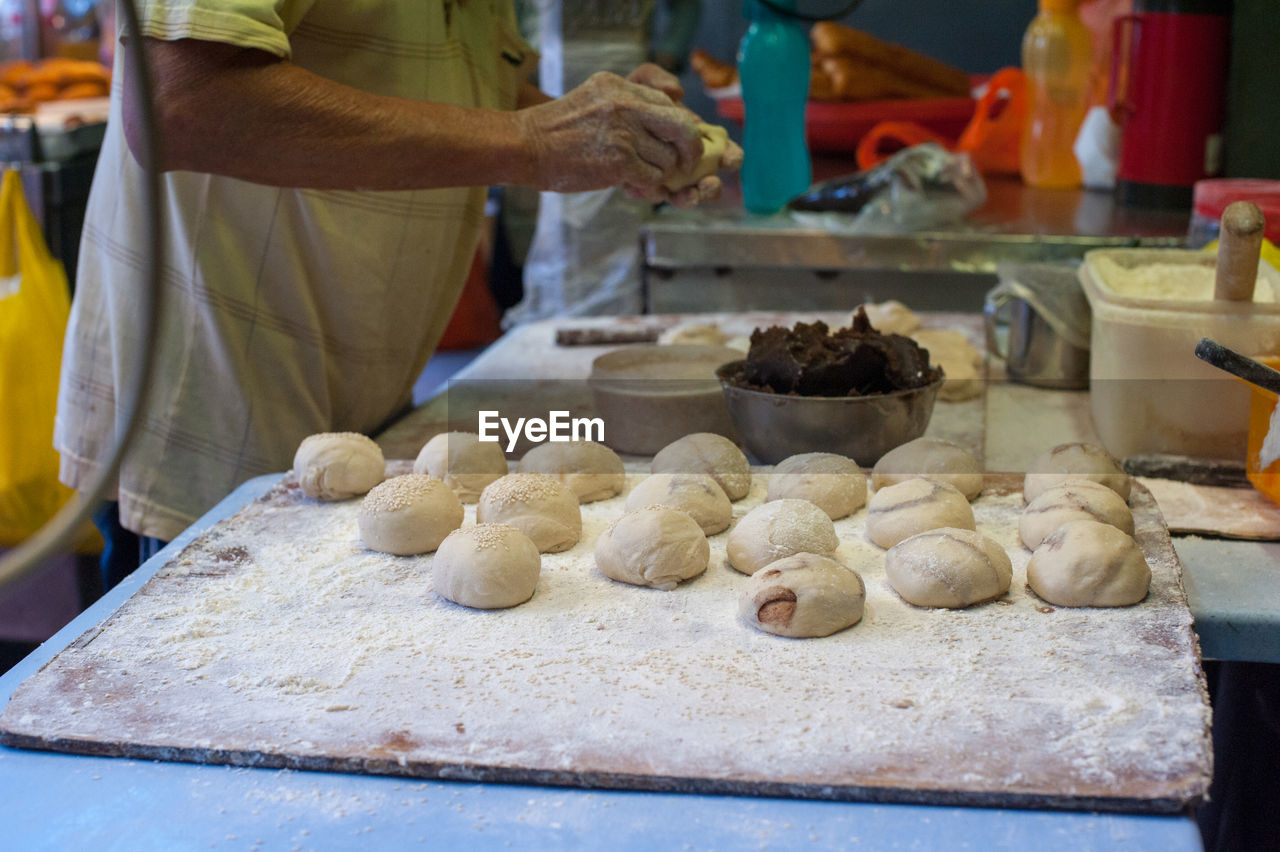 Midsection of man preparing food