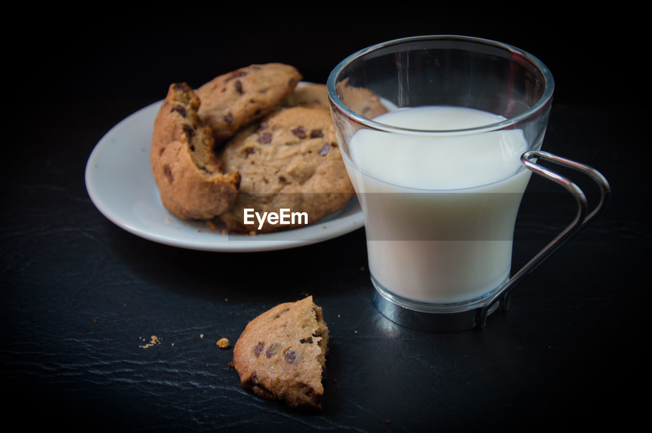 Close-up of cookies with milk on table