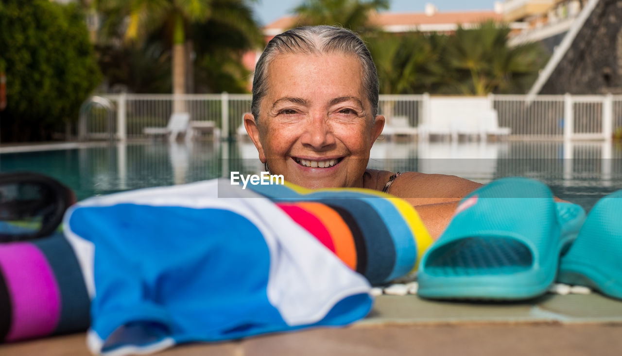 PORTRAIT OF SMILING MAN SWIMMING POOL