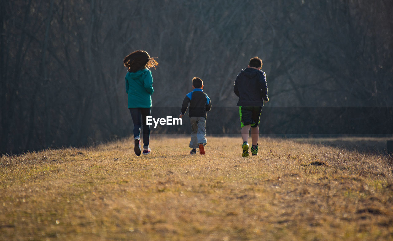 Siblings running on field