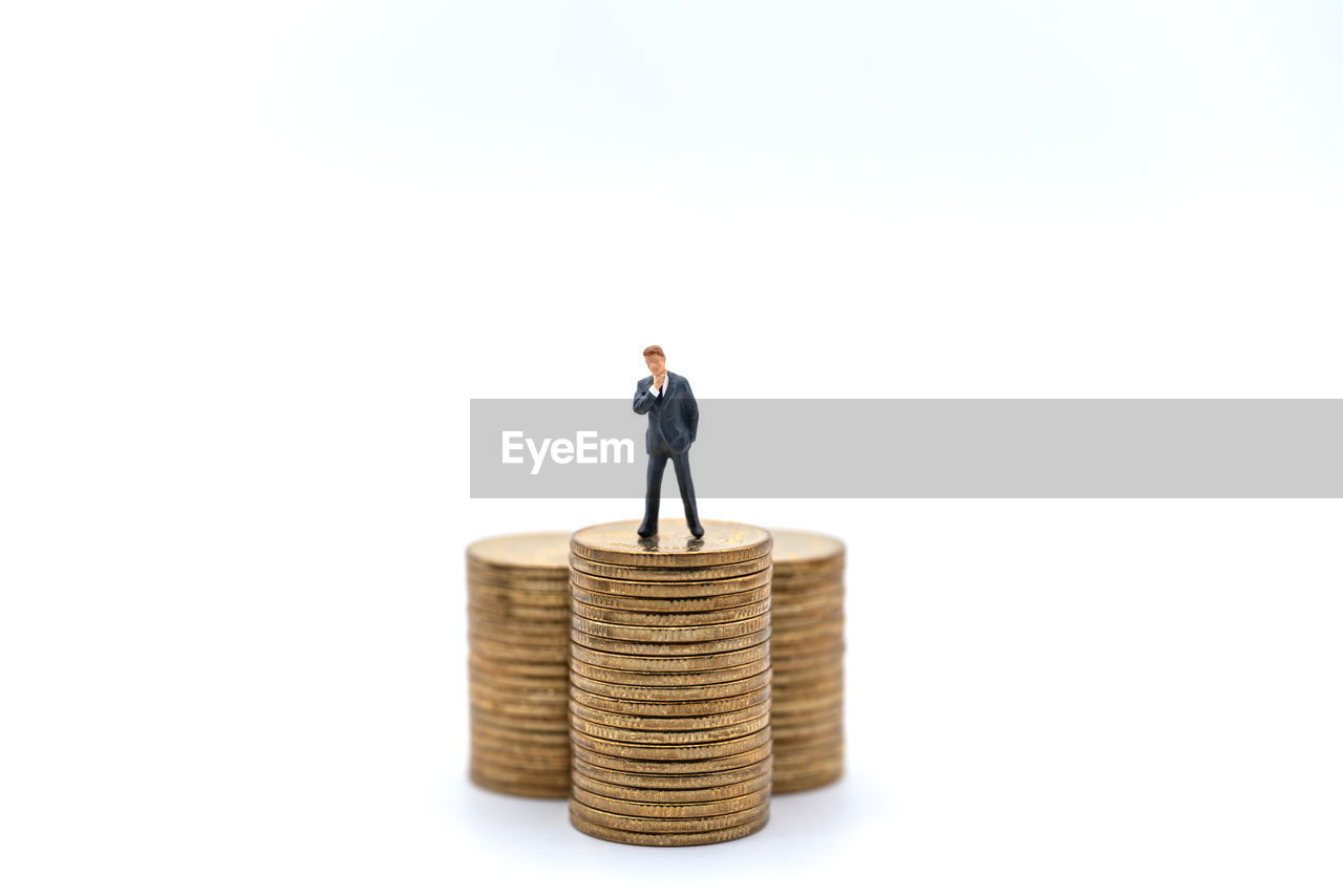 MAN STANDING IN FRONT OF WHITE BACKGROUND