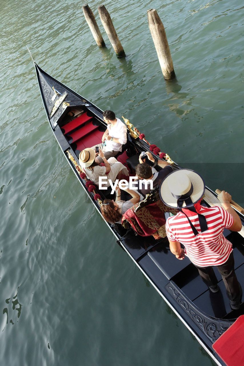 High angle view of people traveling in gondola sailing on river