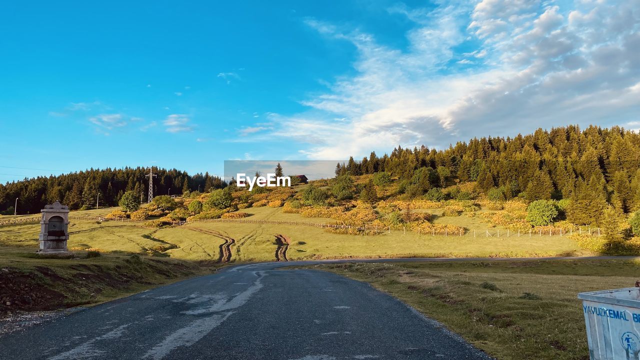 People walking on road against sky