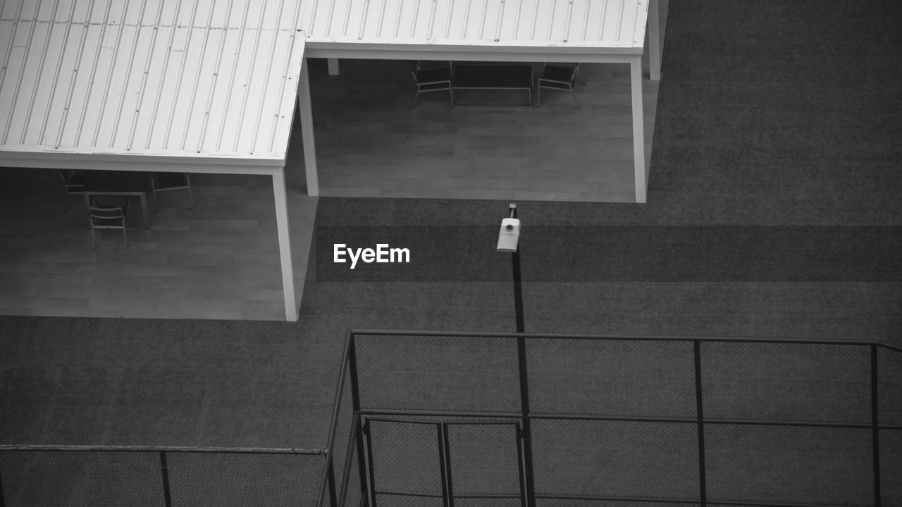 Empty chairs and table against wall in building