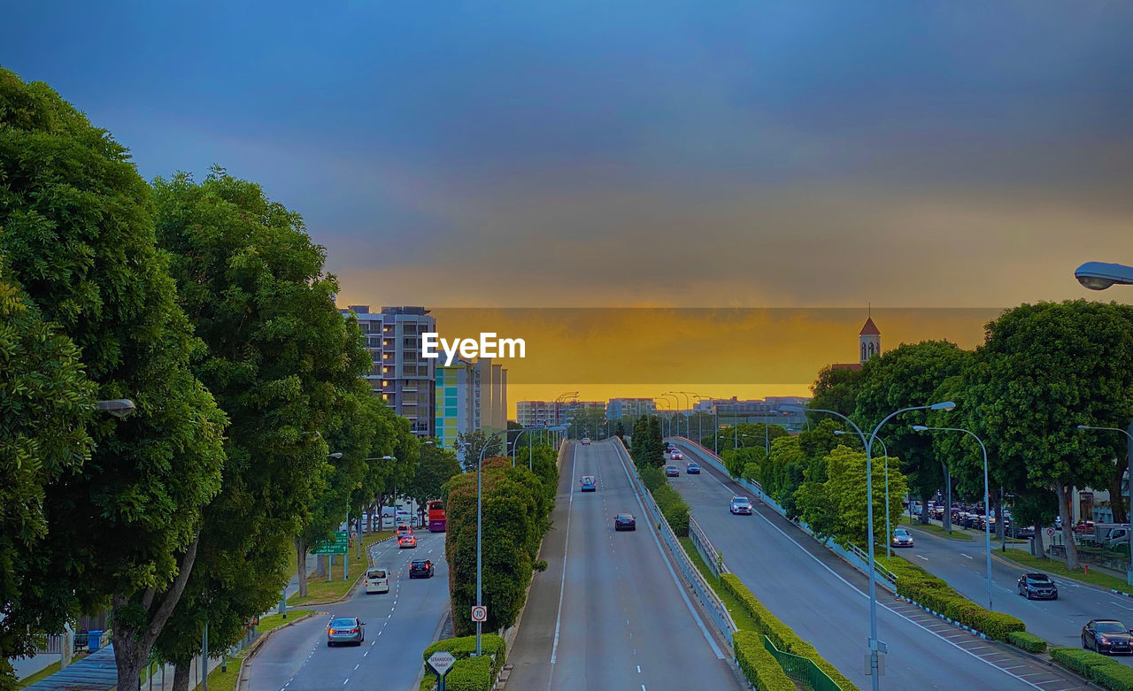 HIGH ANGLE VIEW OF CARS ON ROAD AGAINST SKY