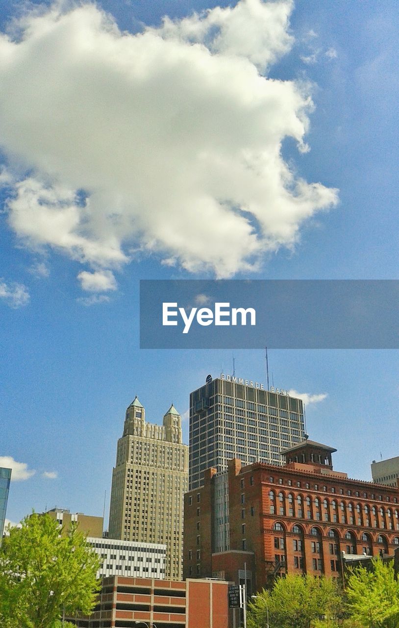 LOW ANGLE VIEW OF BUILDINGS AGAINST CLOUDY SKY