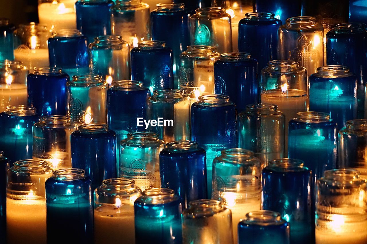 Full frame shot of lit tea light candles in church