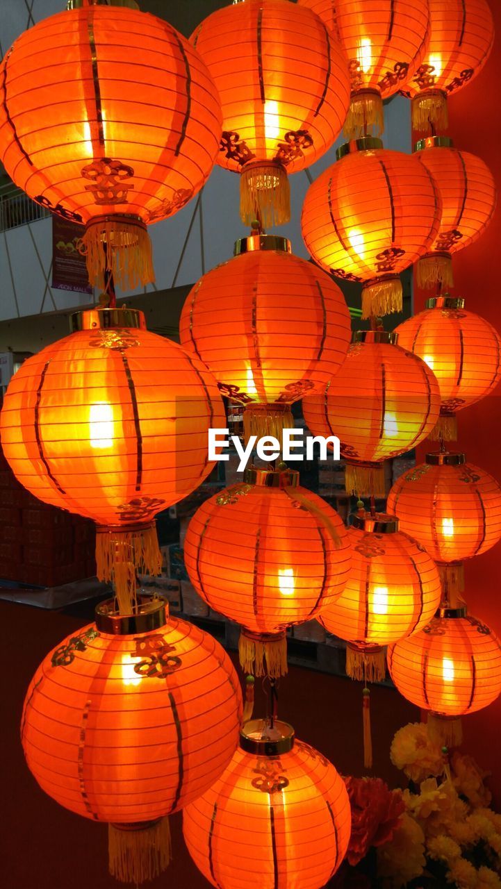 LOW ANGLE VIEW OF ILLUMINATED LANTERNS AT NIGHT