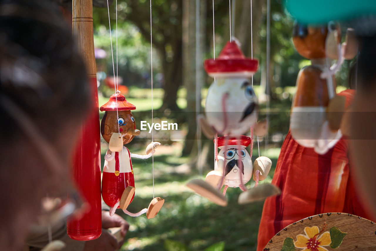 Close-up of figurines hanging outdoors