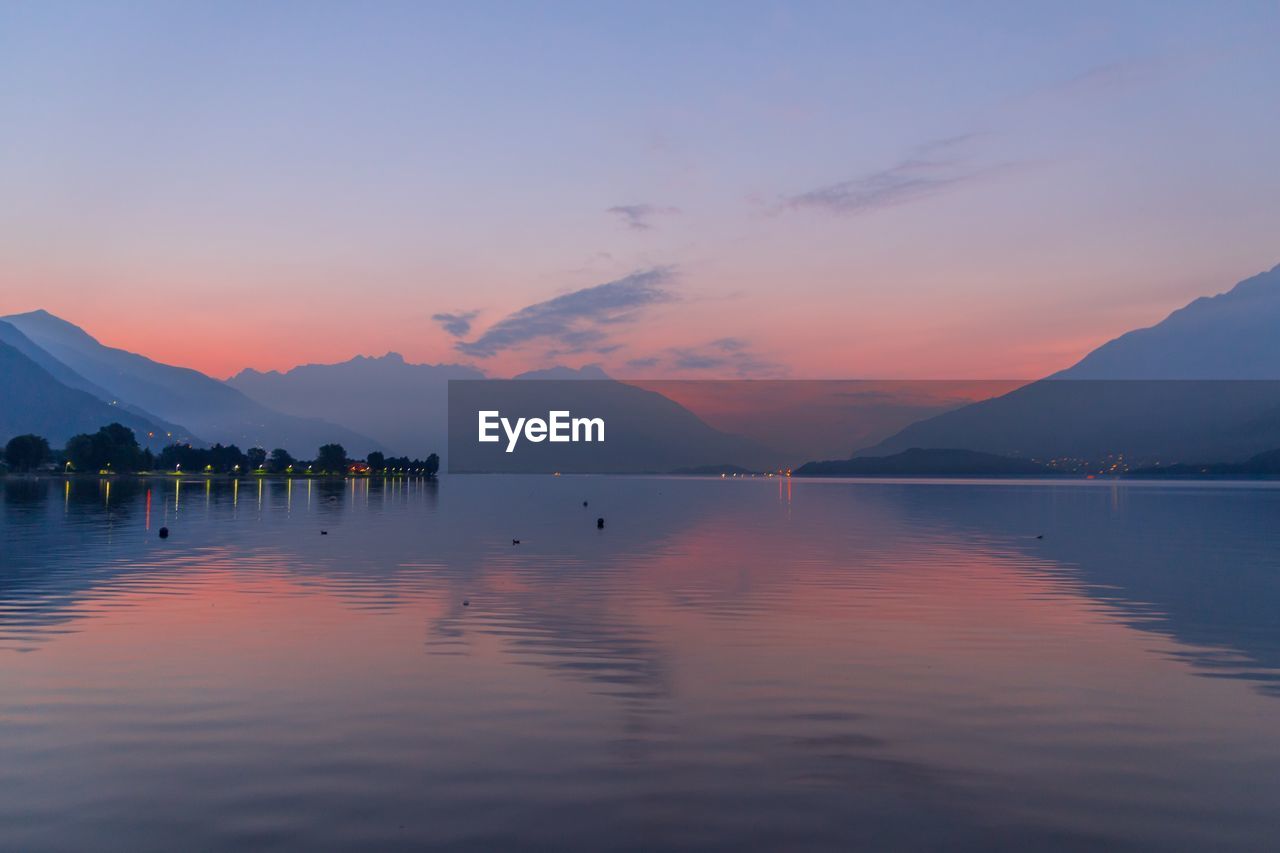 Scenic view of lake against sky during sunset