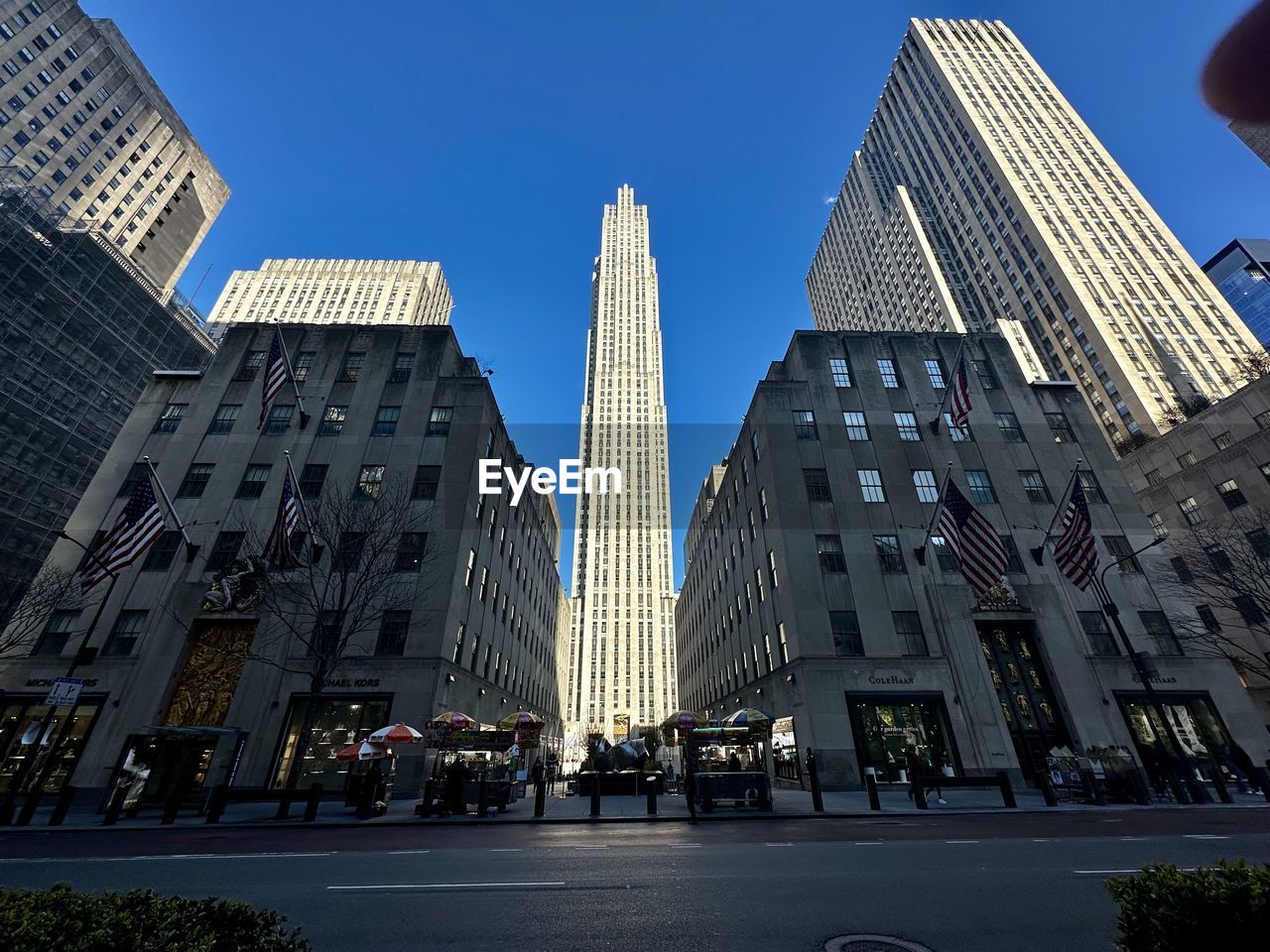 Low angle view of modern buildings against sky - rockefeller center - new york