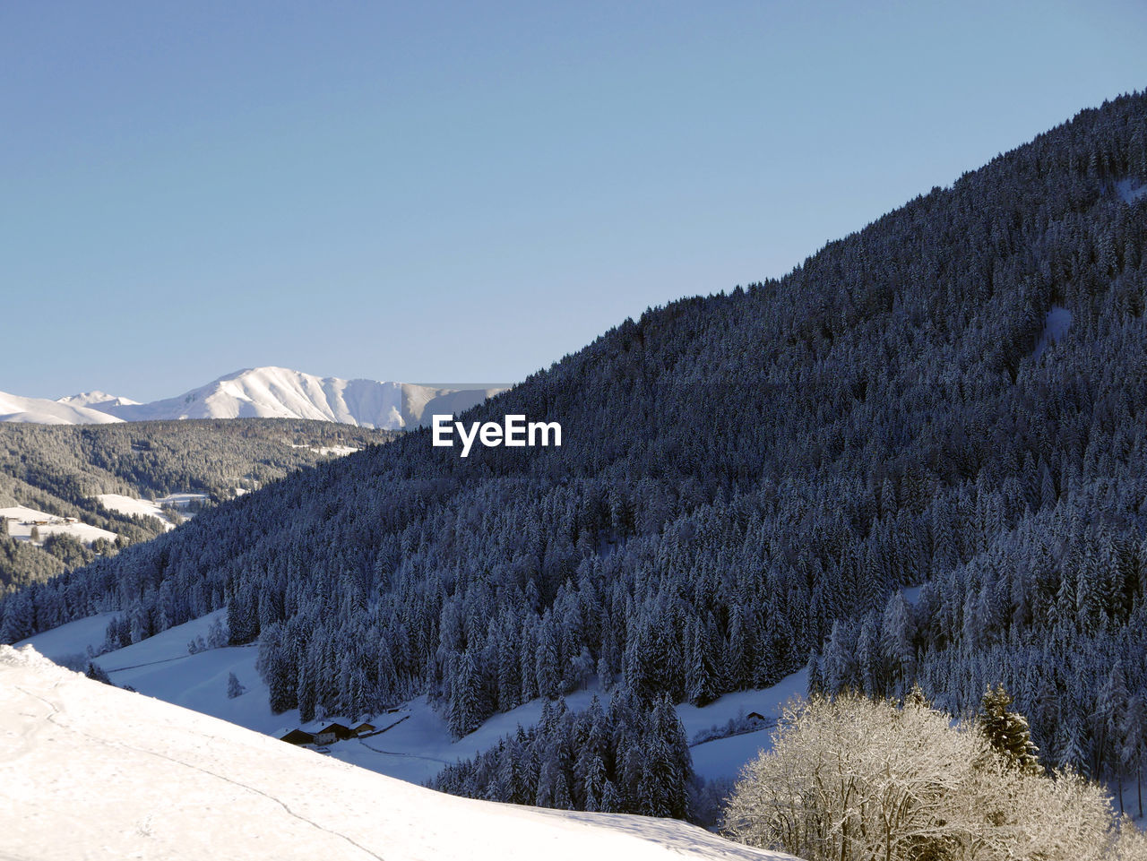 Snowcapped mountains against clear blue sky