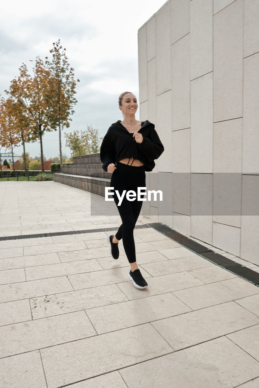 Low section of woman walking on street