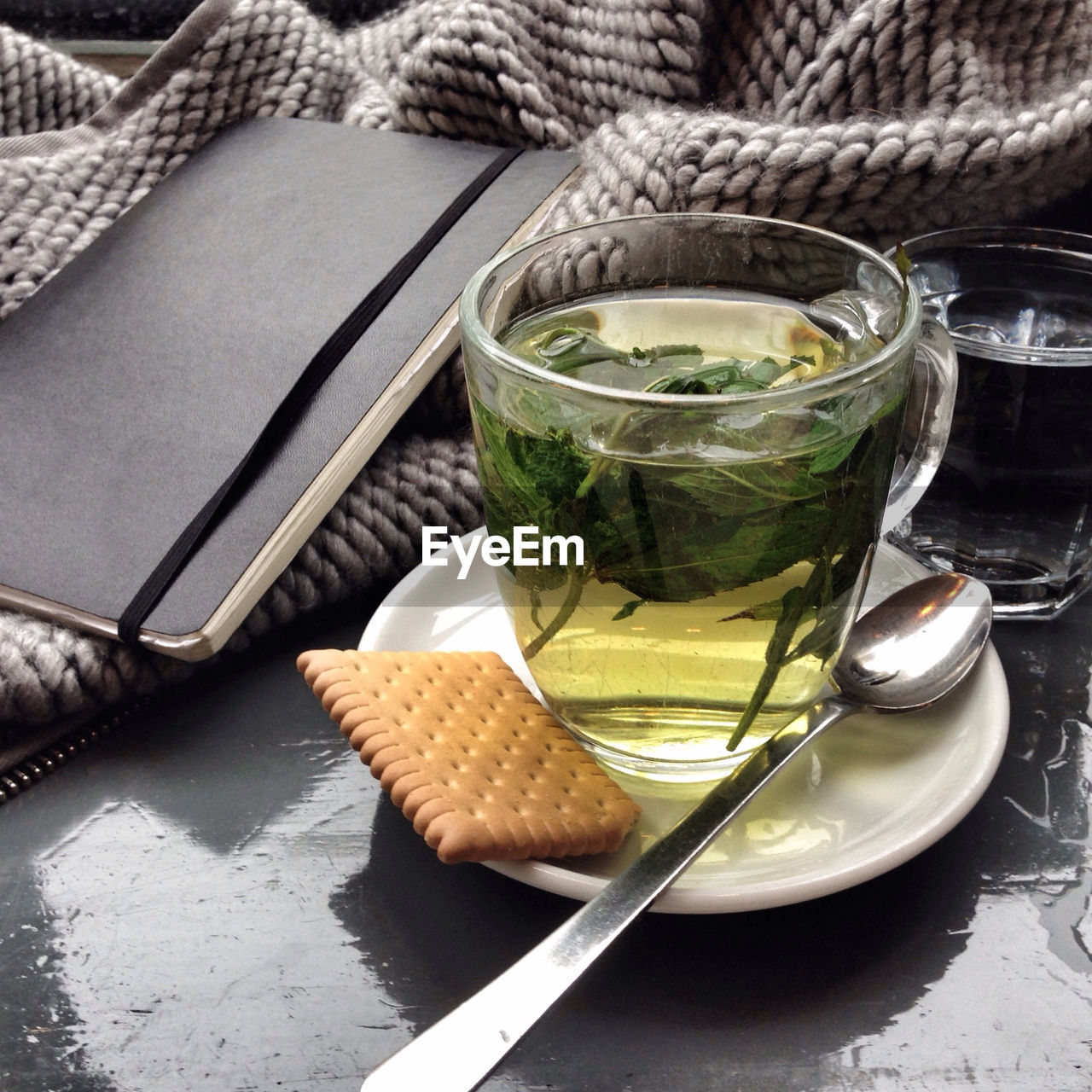 Close-up of mint tea and biscuit on table