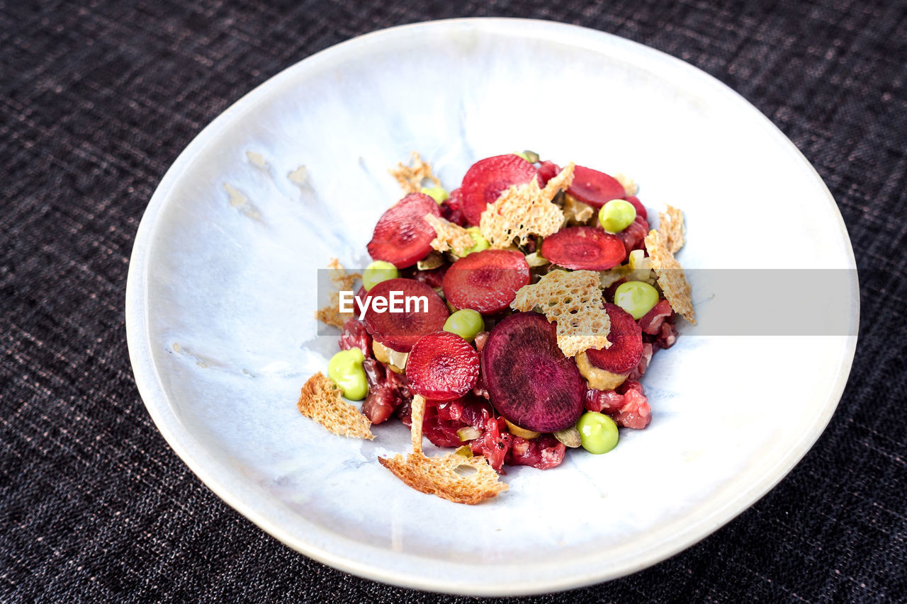 High angle view of fruits in plate on table