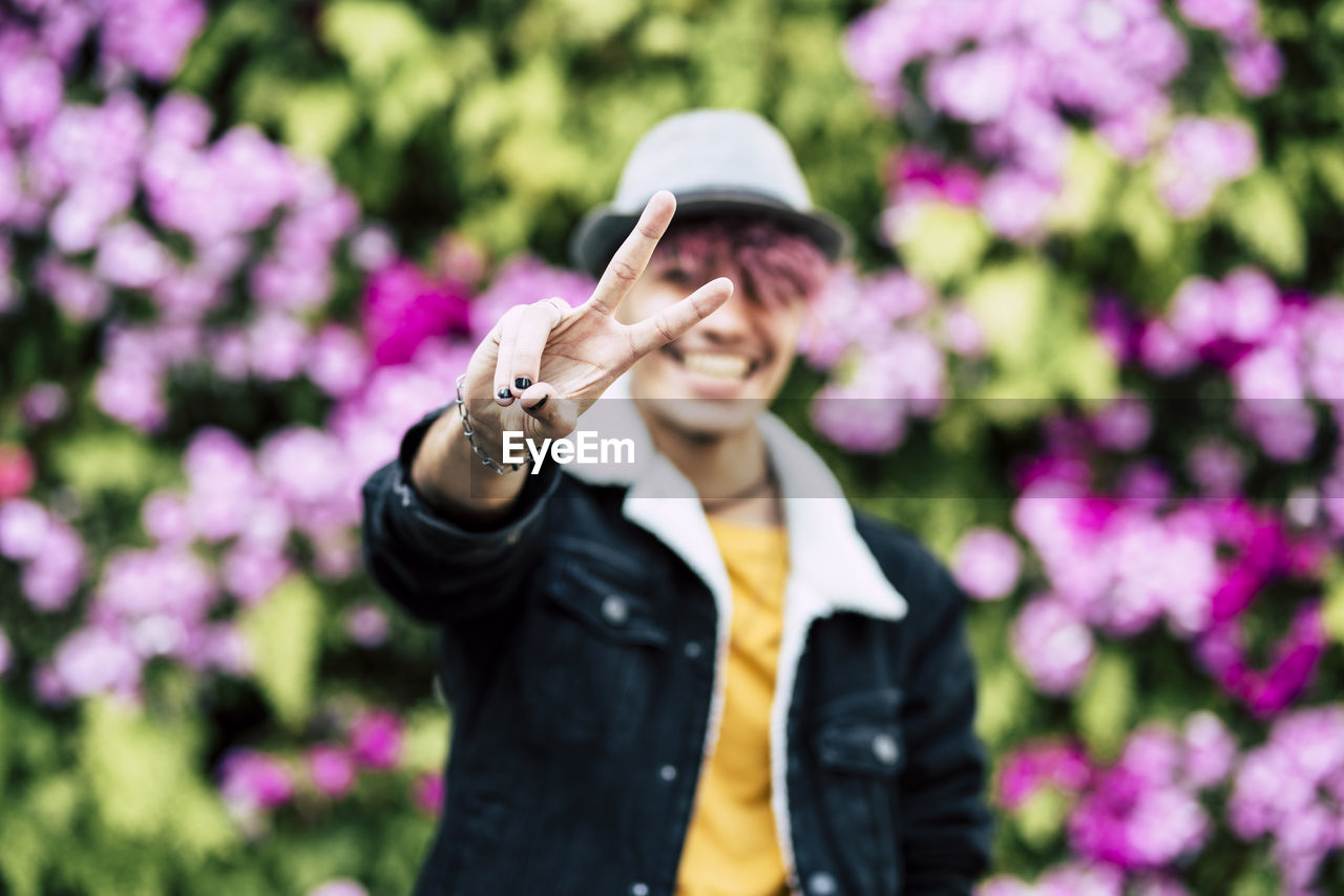 Portrait of smiling man wearing hat against blurred background