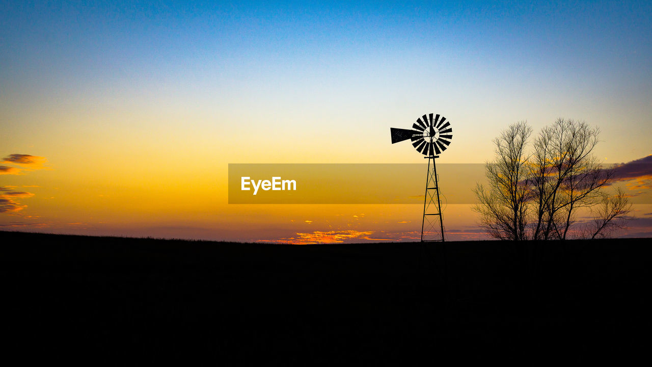 LOW ANGLE VIEW OF SILHOUETTE TREES AGAINST SKY AT SUNSET