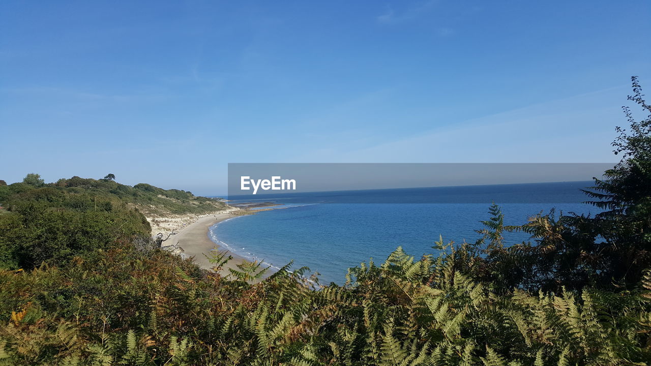 Scenic view of sea against blue sky