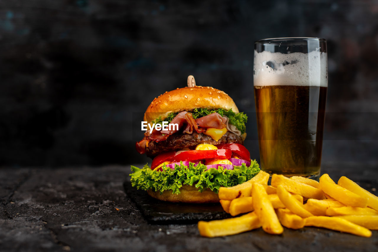 Juicy hamburger with fries and beer