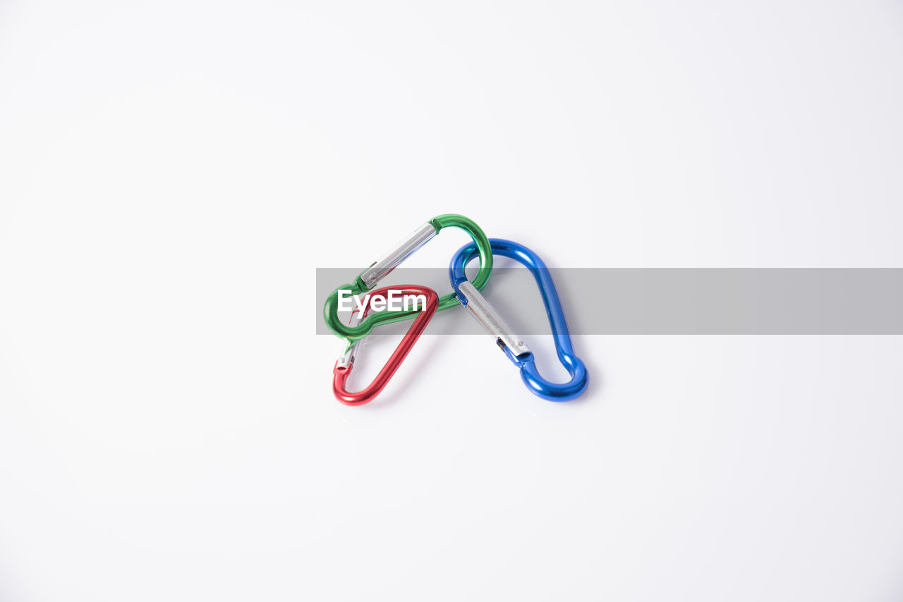 High angle view of carabiners against white background