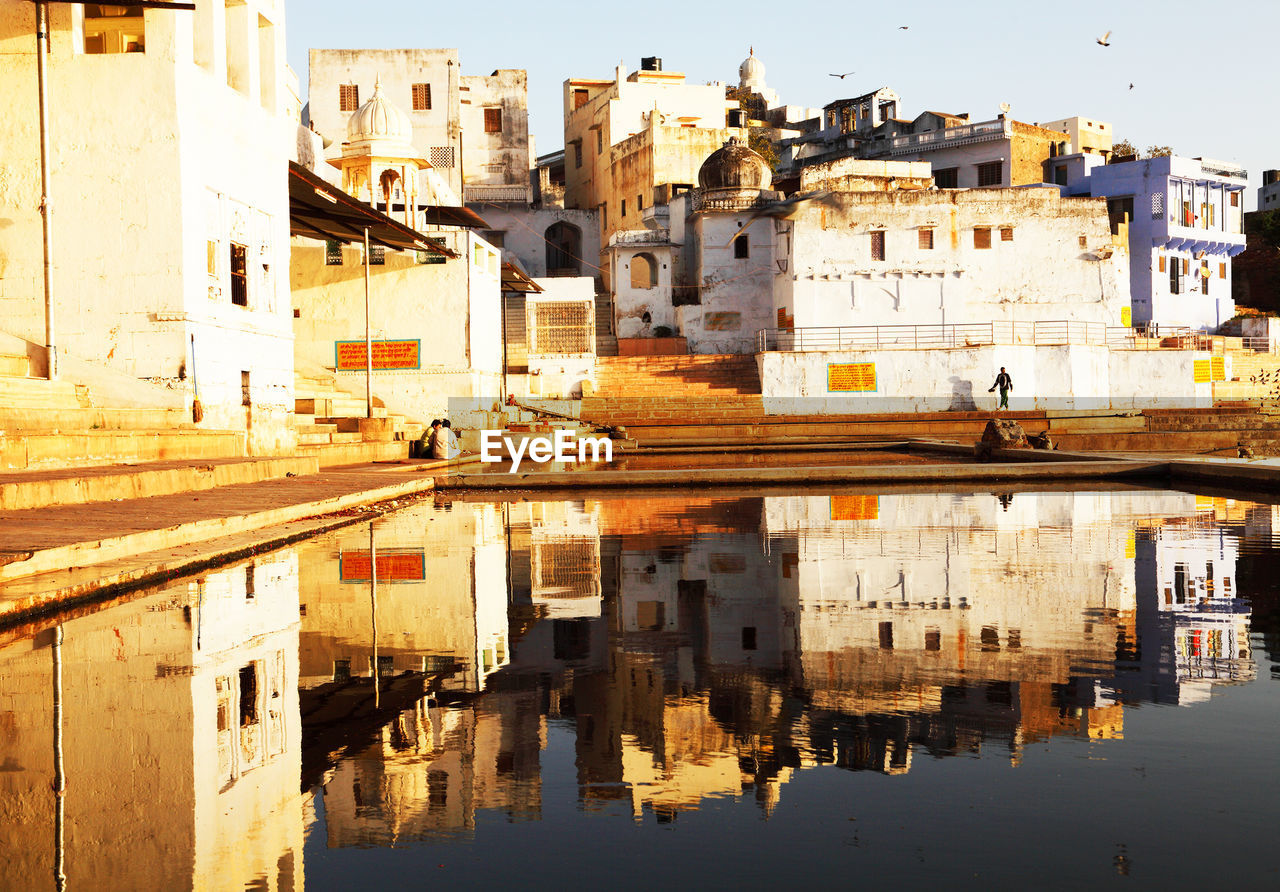 Houses reflecting in pushkar lake during sunset