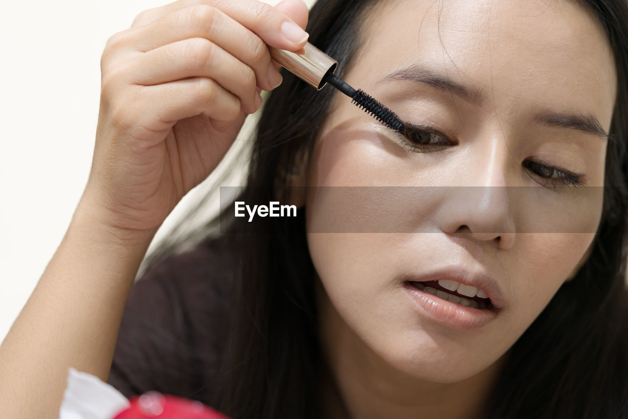 Close-up of woman applying mascara