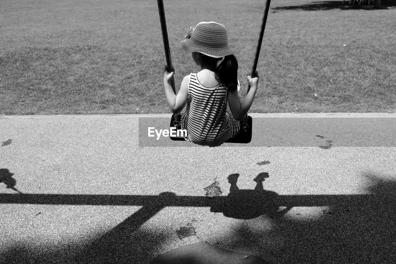 Rear view of a girl on swing