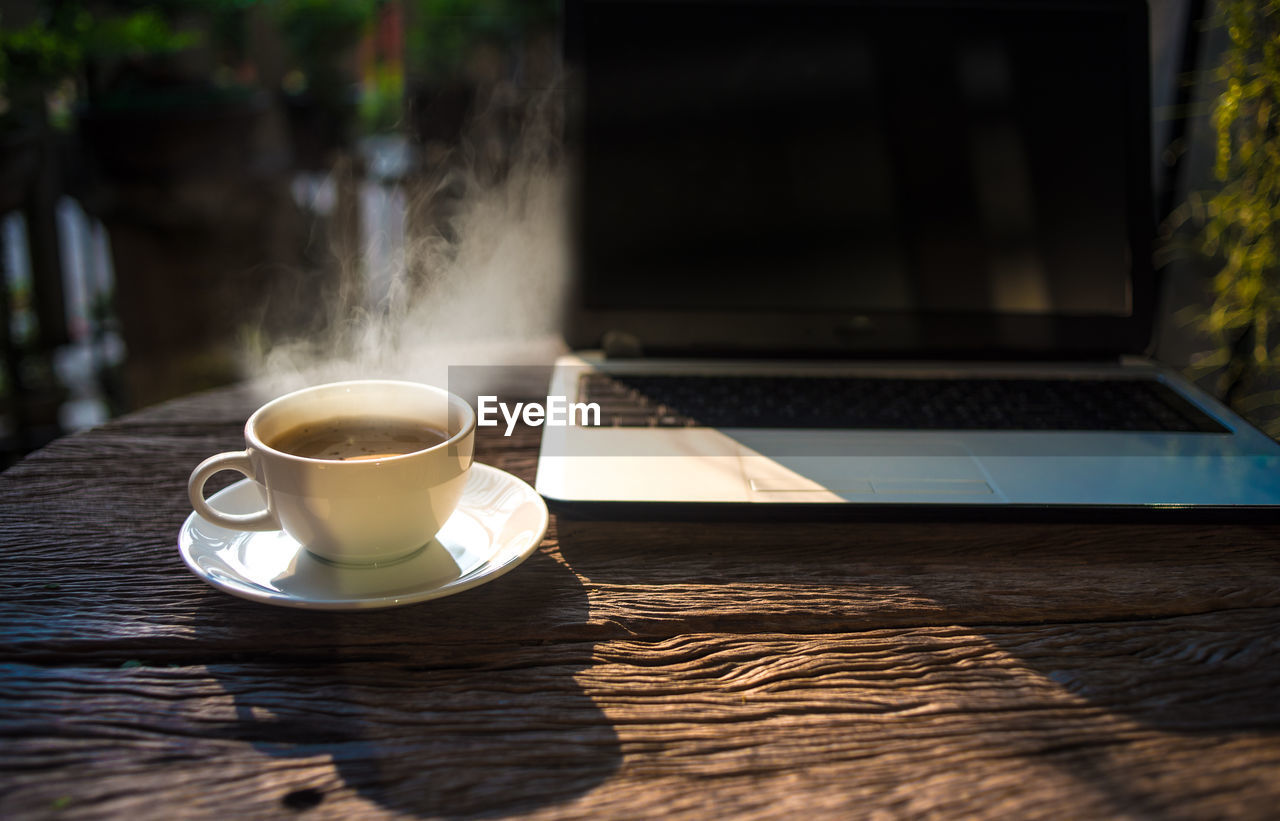 COFFEE CUP ON TABLE WITH SPOON