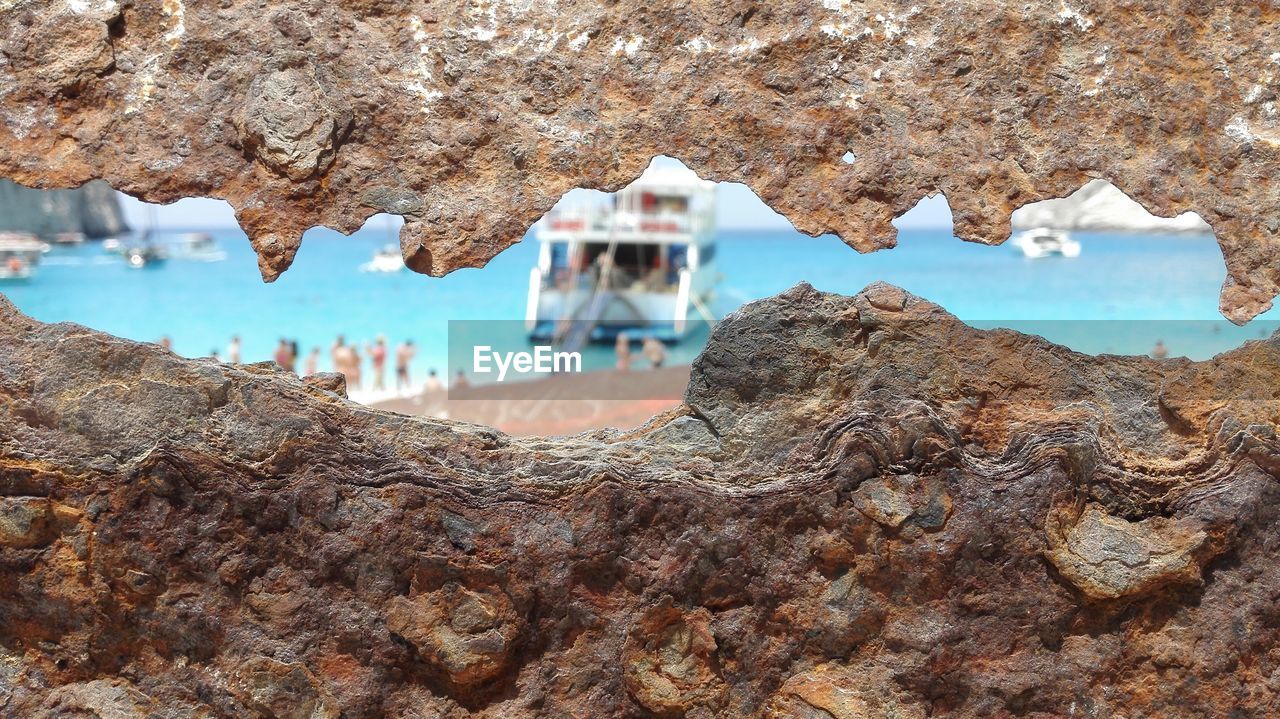 CLOSE-UP OF ROCK FORMATION IN SEA