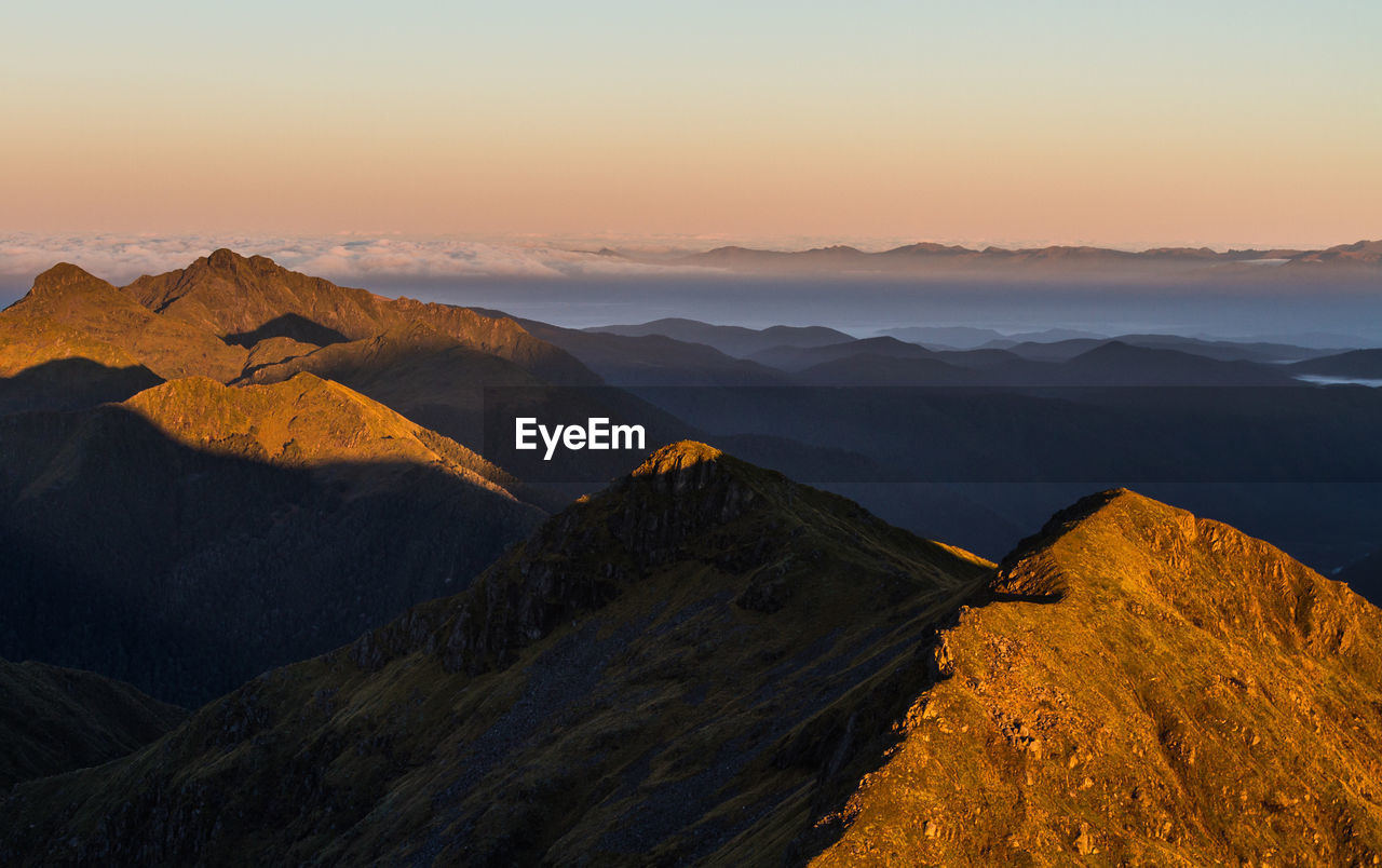 Scenic view of mountains against sky during sunrise