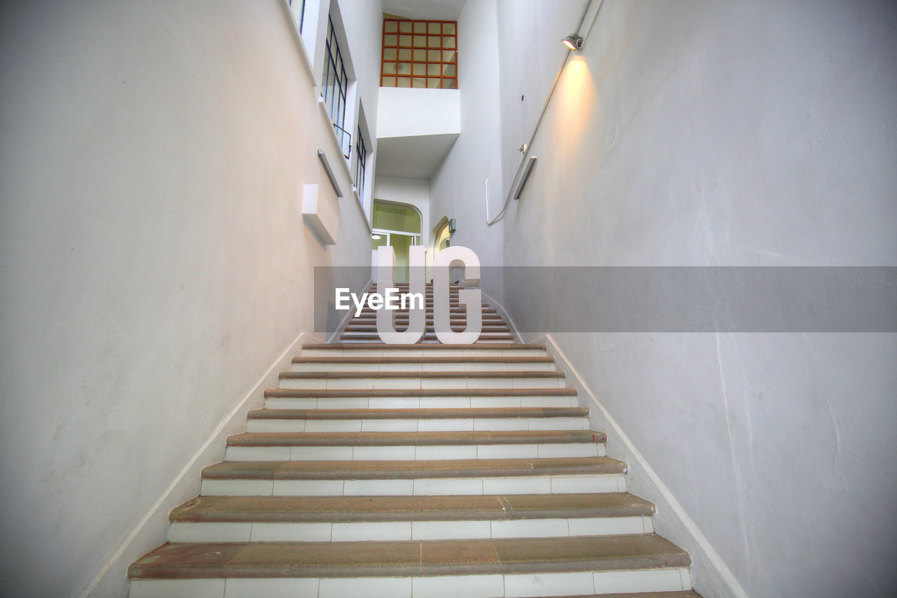 LOW ANGLE VIEW OF STEPS IN ILLUMINATED BUILDING