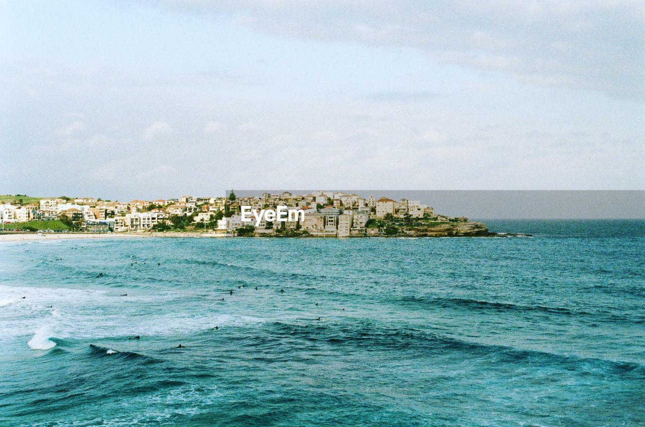 Scenic view of sea and buildings against sky