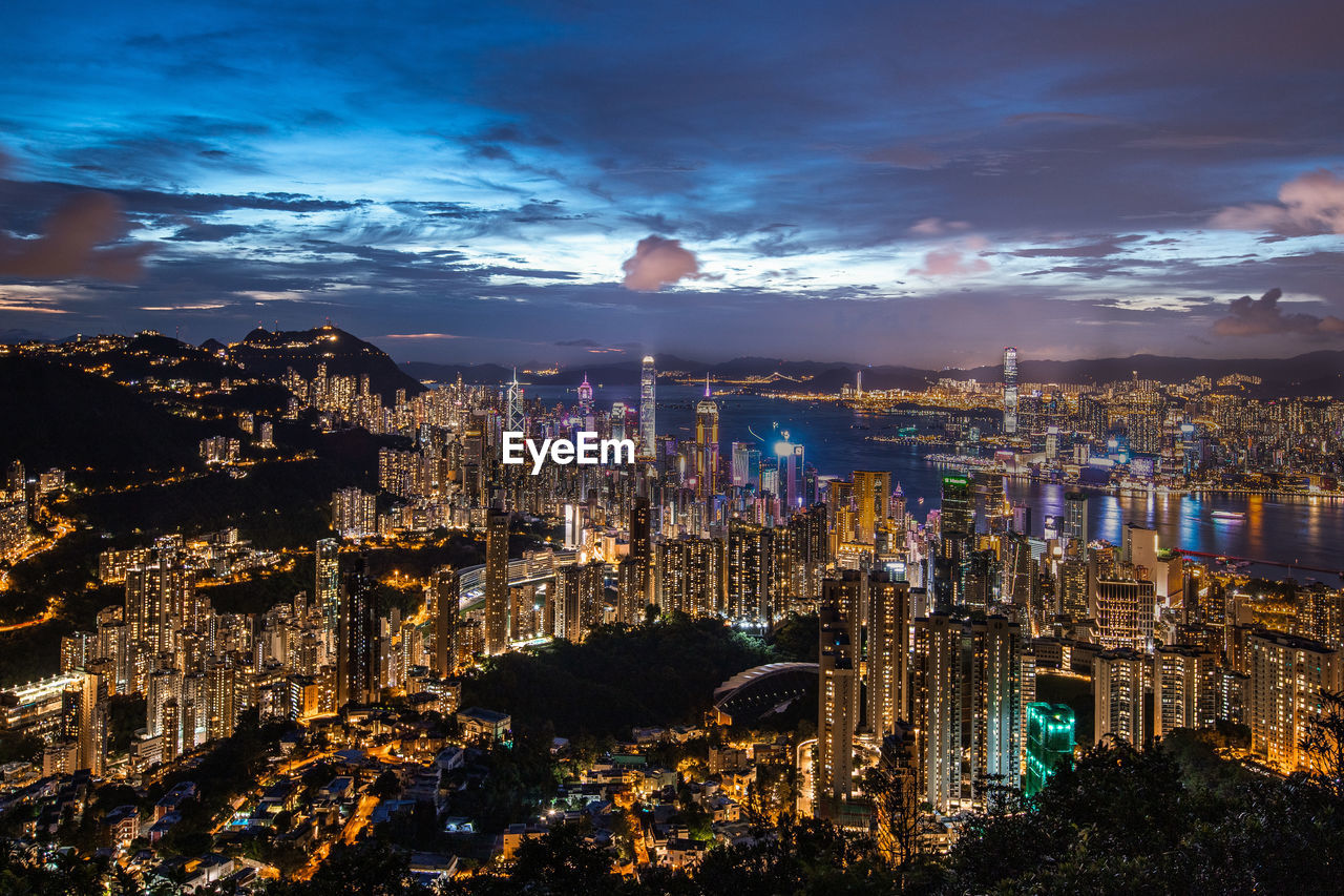 high angle view of illuminated buildings in city at night