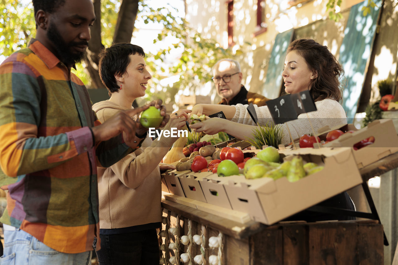 portrait of smiling friends with food at table