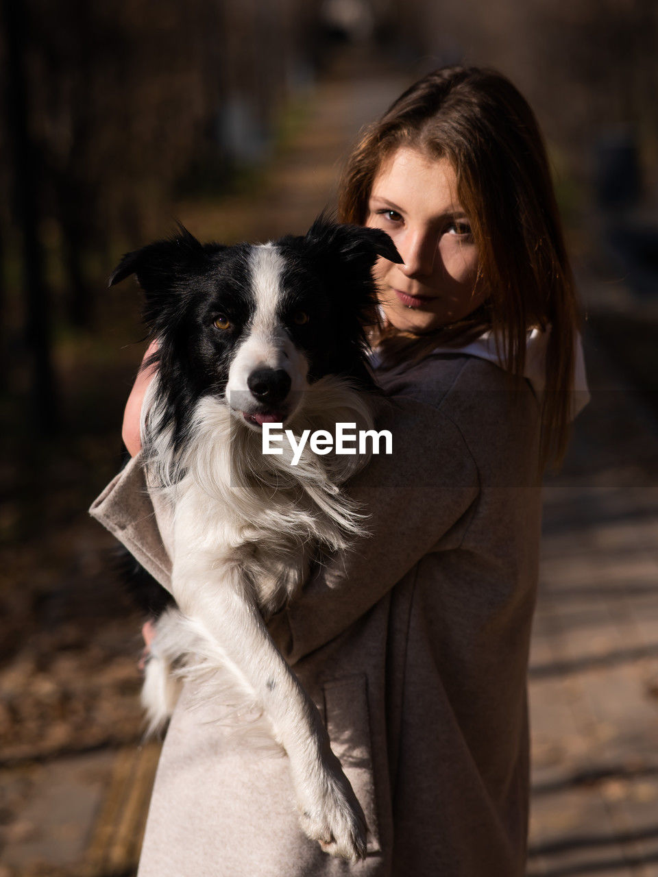 portrait of woman holding dog