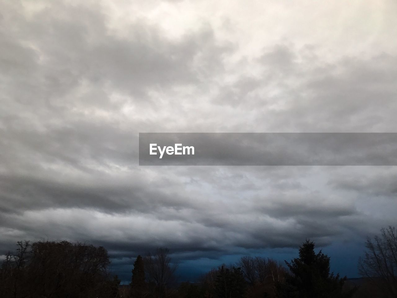 SCENIC VIEW OF STORM CLOUDS OVER LANDSCAPE