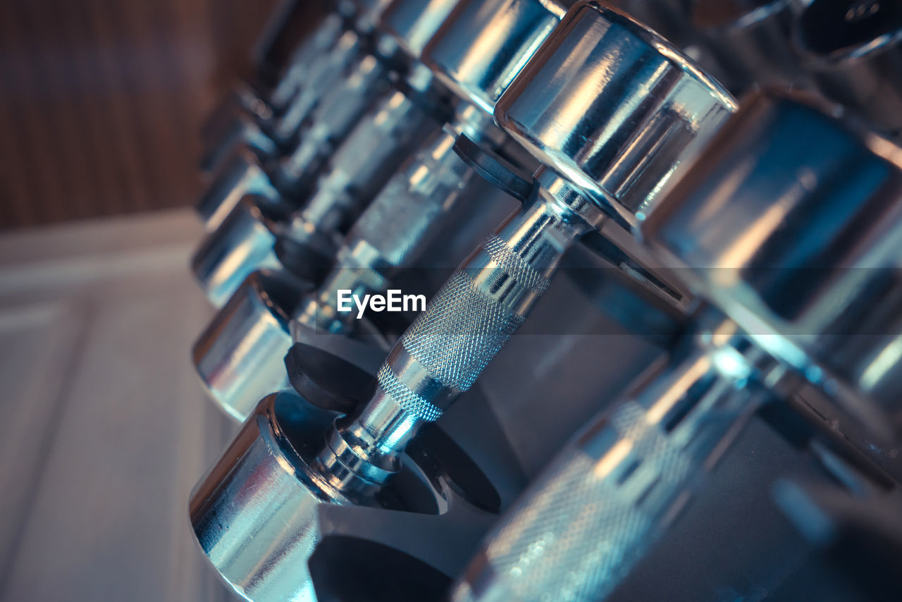 Close-up of dumbbells on rack in gym