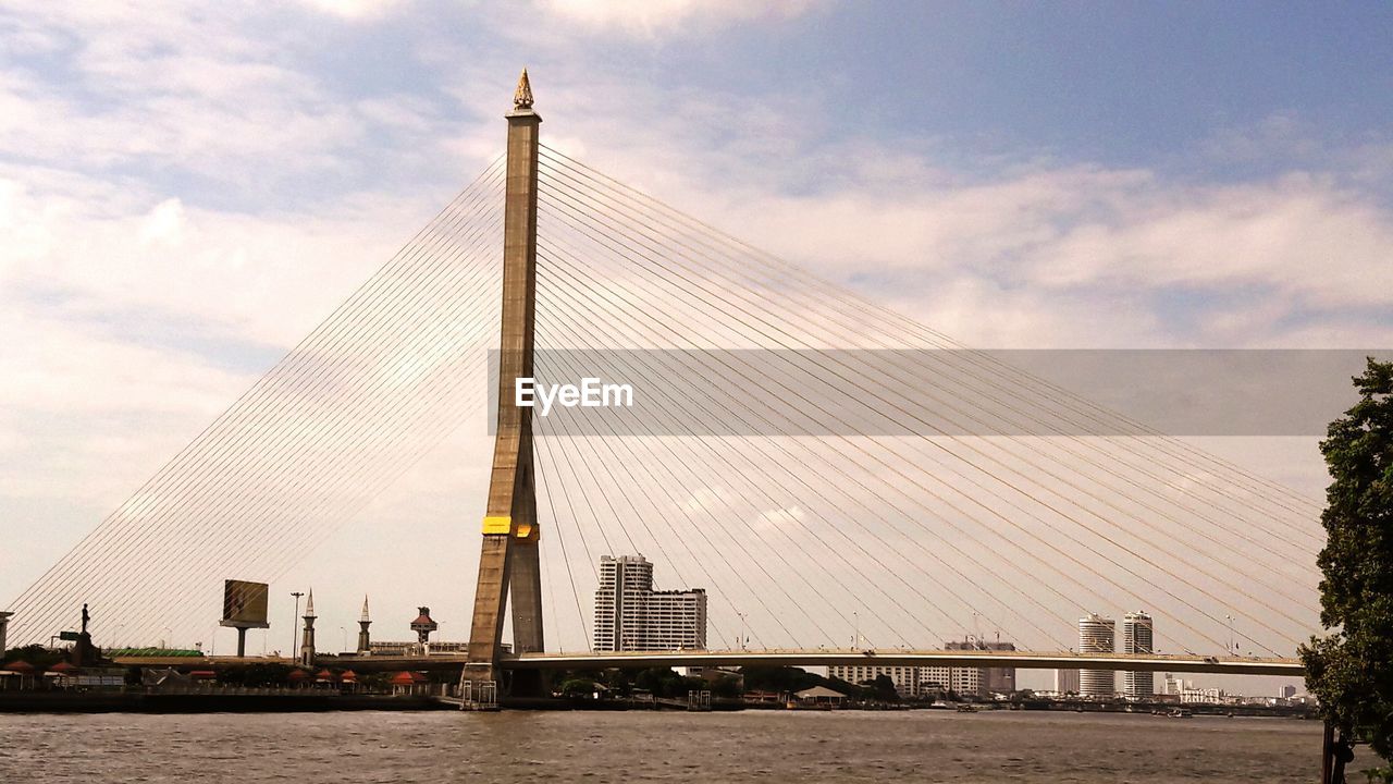 Bridge over river with city in background