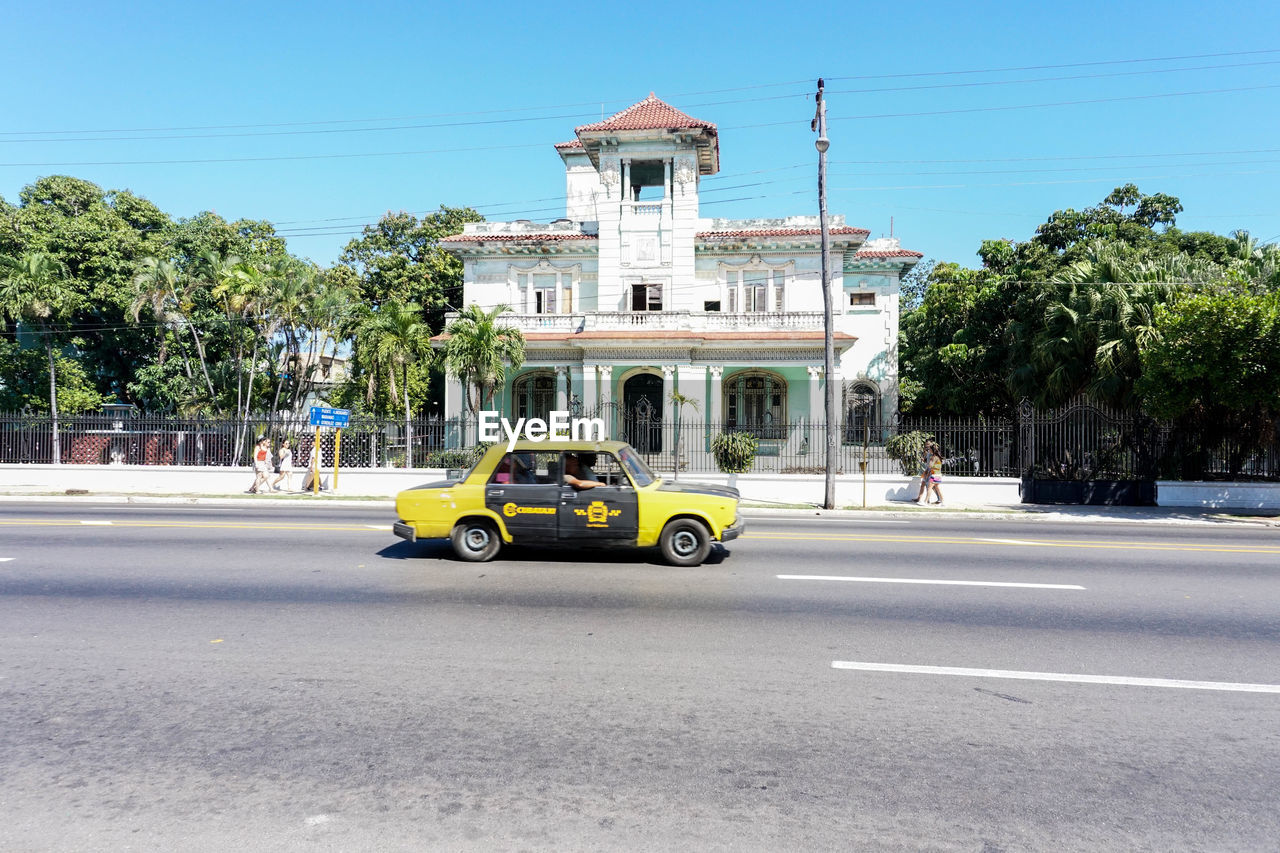 CAR ON STREET AGAINST SKY