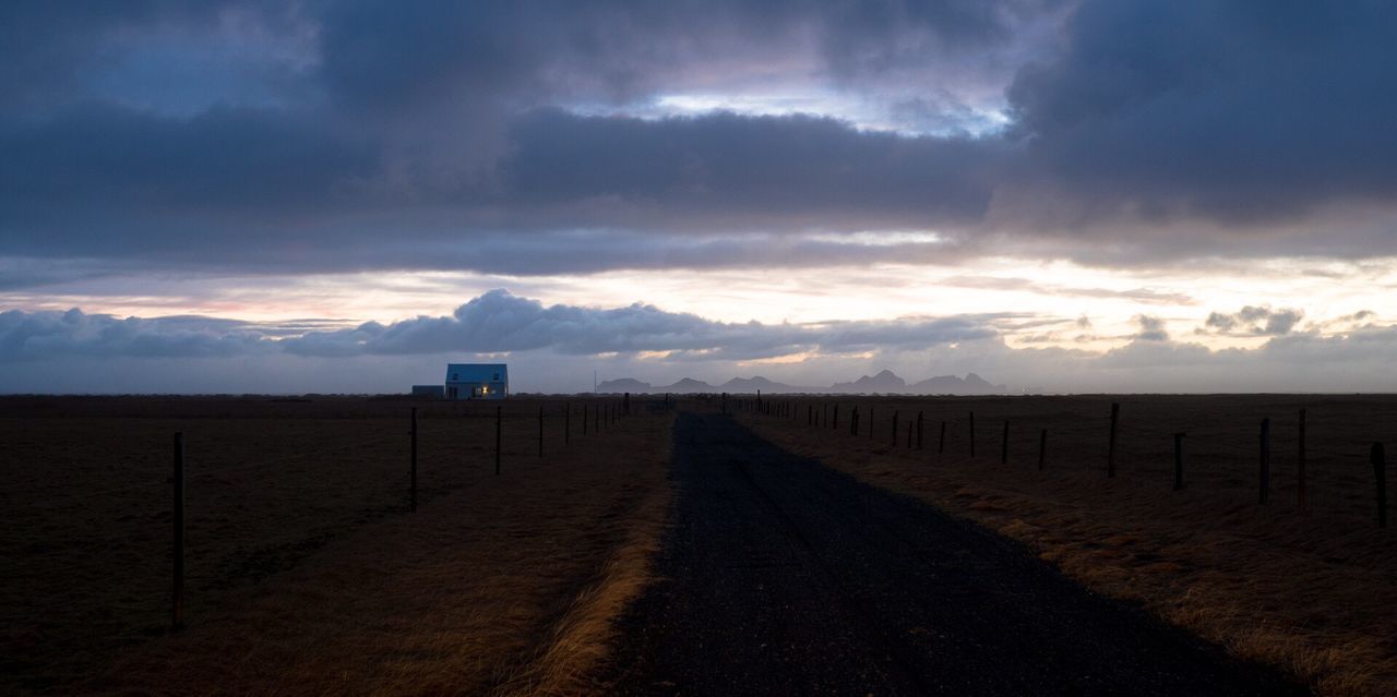 VIEW OF FIELD AGAINST STORM CLOUDS