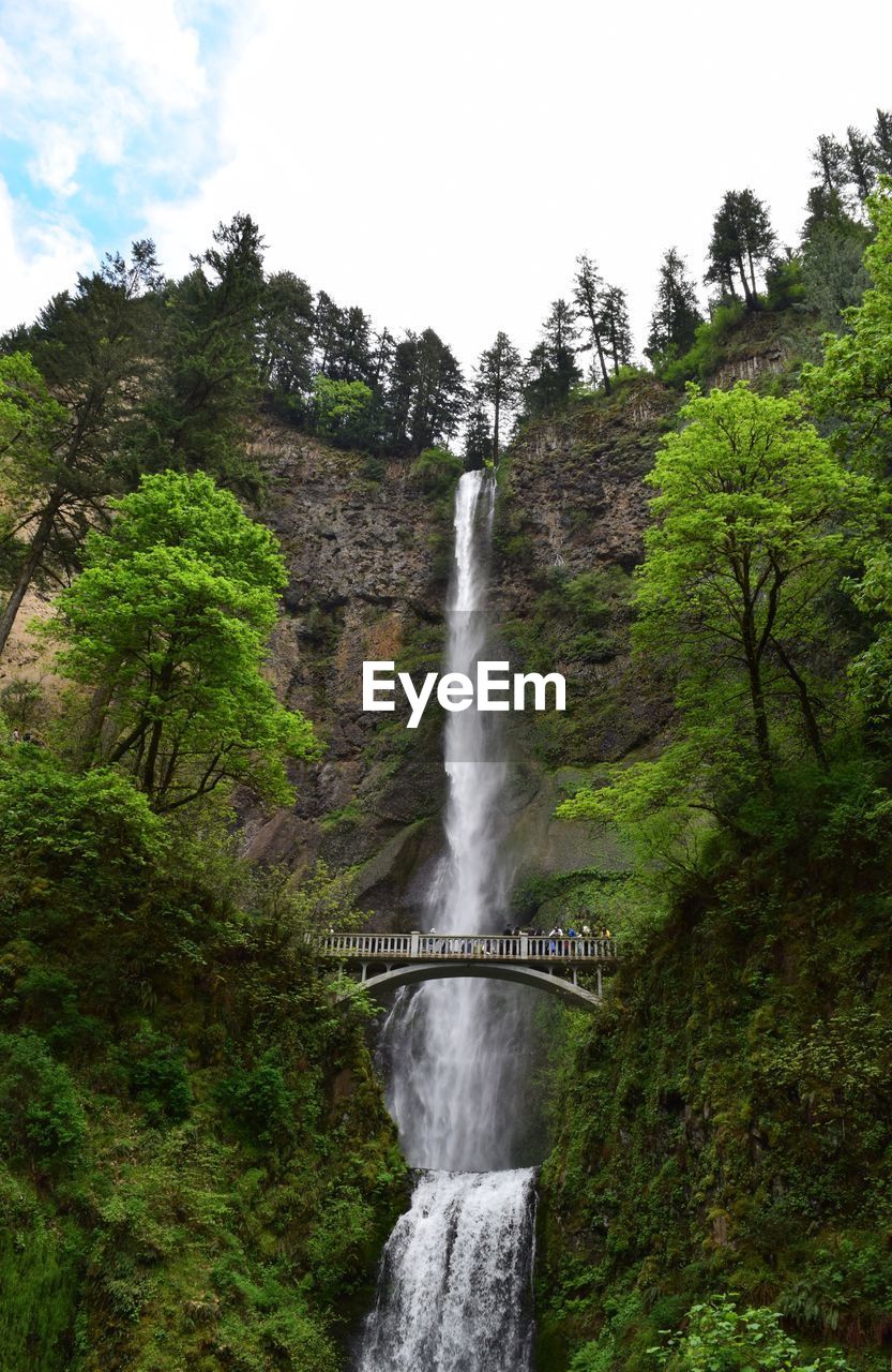 Scenic view of waterfall against sky