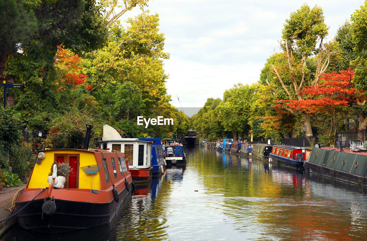 BOAT MOORED ON RIVER AGAINST SKY