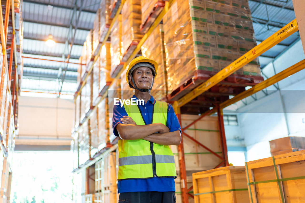 LOW ANGLE VIEW OF MAN WORKING AT BUILDING