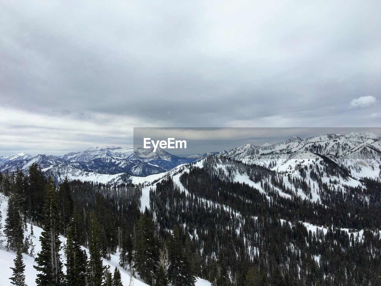 SNOW COVERED MOUNTAINS AGAINST SKY