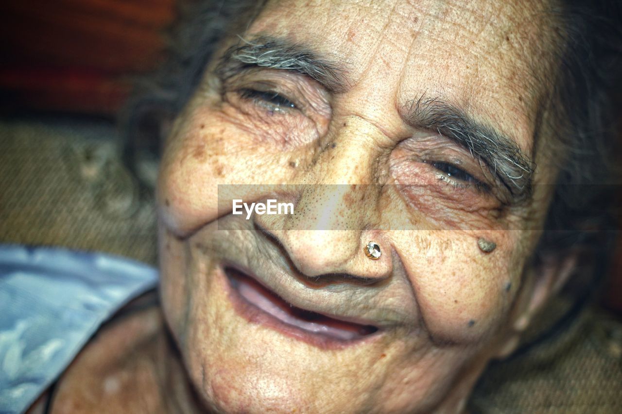 Close-up of smiling senior woman at home