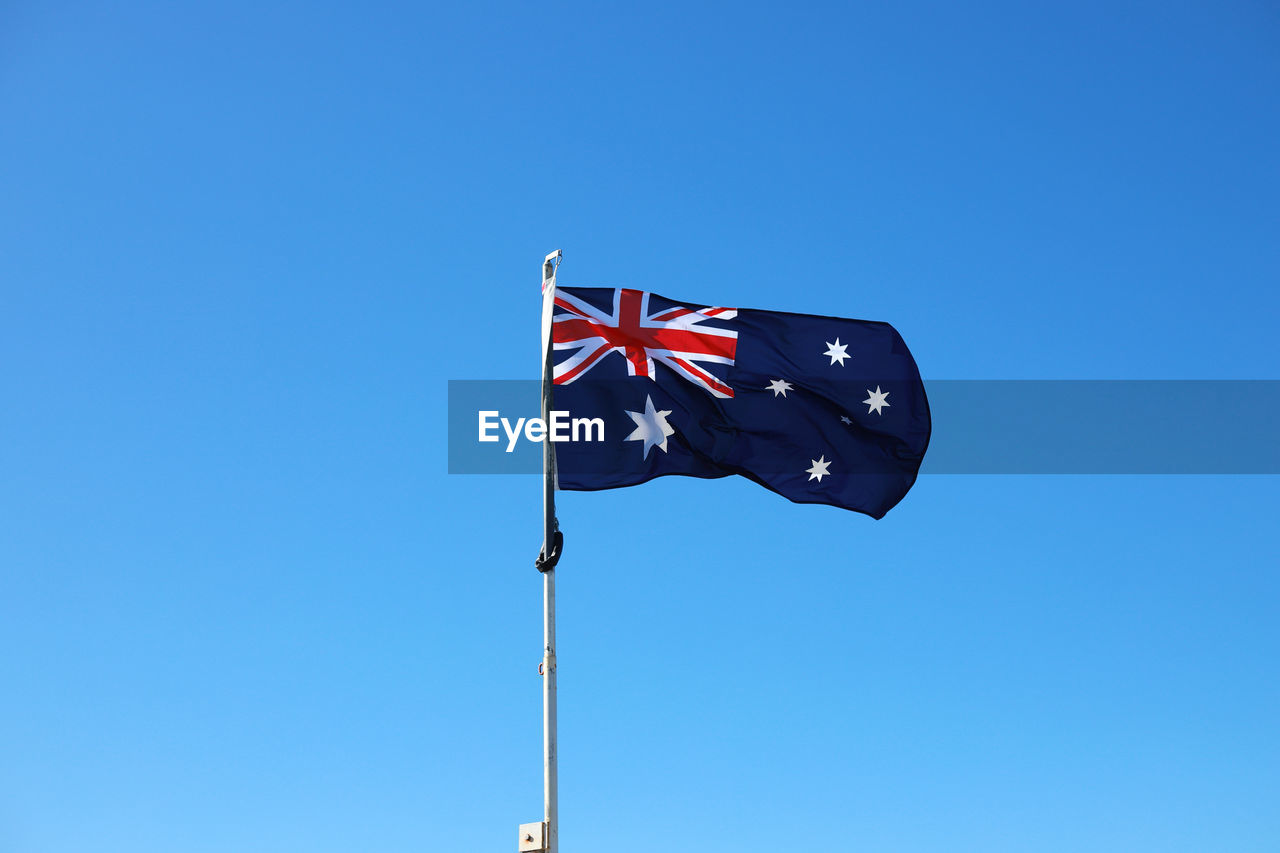 Low angle view of australian flag against clear blue sky