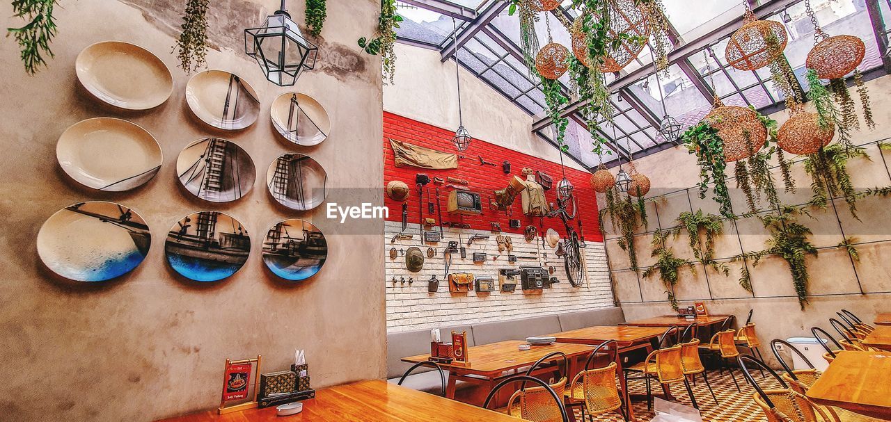 HIGH ANGLE VIEW OF CHAIRS AND TABLES ON WALL