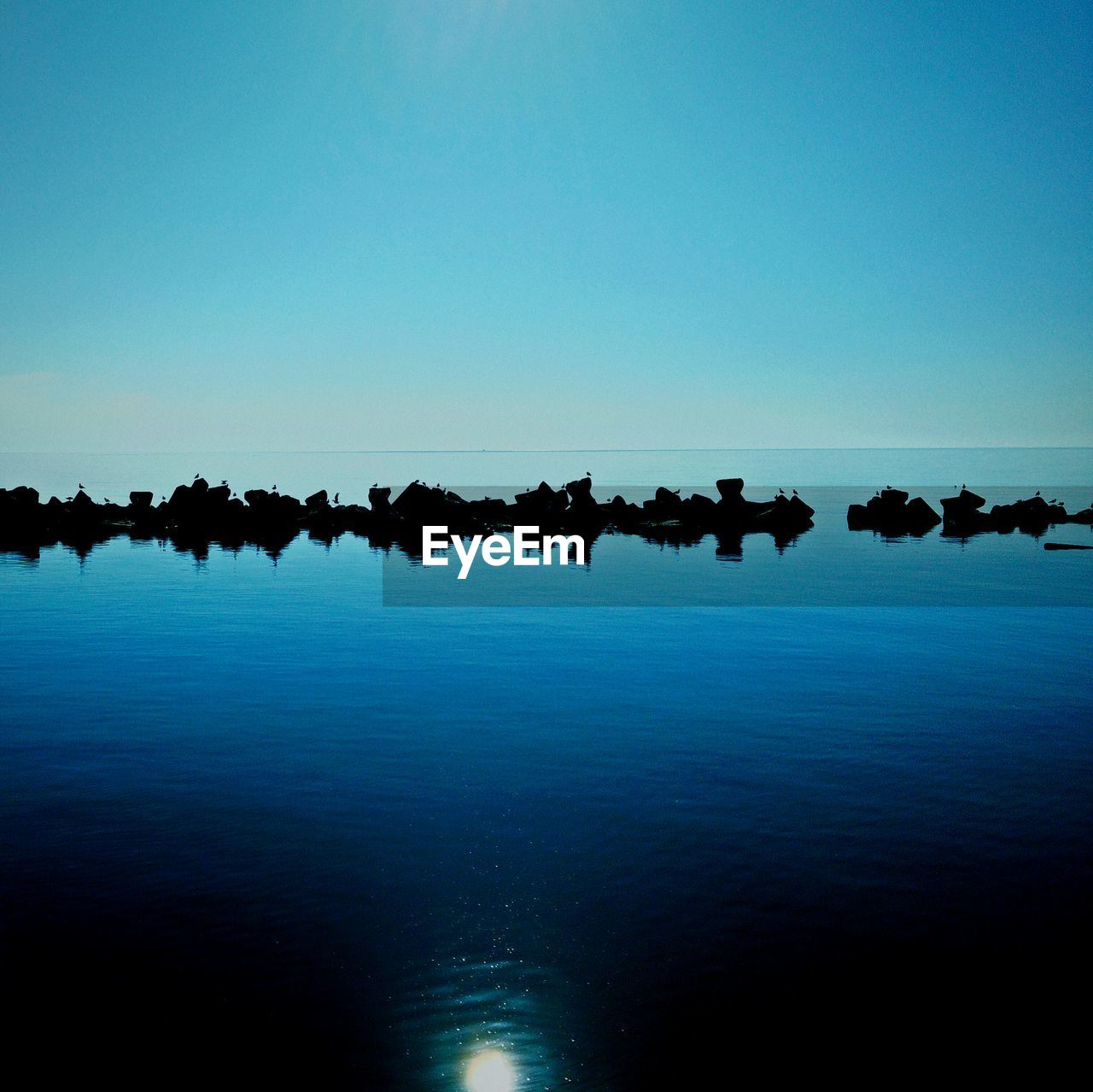 SCENIC VIEW OF CALM SEA AGAINST CLEAR SKY